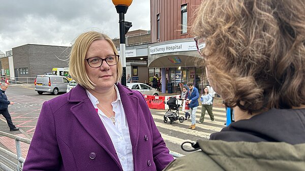 Zoe Franklin talks to a Guildford resident outside of the Royal Surrey Hospital