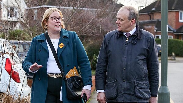 Zoe Franklin and Ed Davey walk together in conversation.