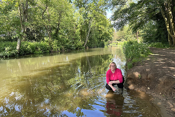 Zöe Franklin crouches in the river